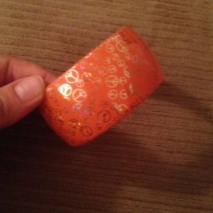Orange peace sign bangle bracelet.