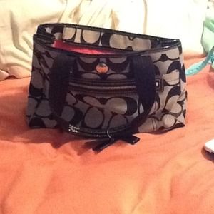 Black and grey coach purse with pink interior