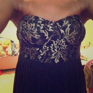 Black pleated dress with gold detail.