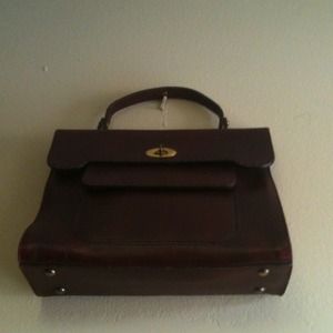 Vintage leather handbag with brass handles