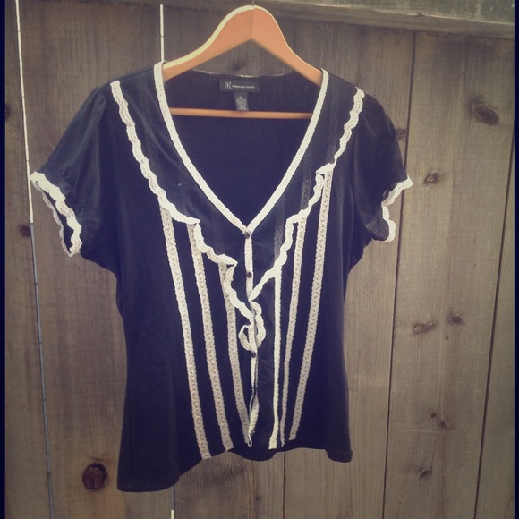 Black blouse with white lace and some ruffly poof.