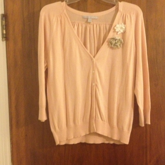 Light coral color cardigan.