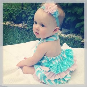 Cotton aqua and pink chevron ruffled romper.