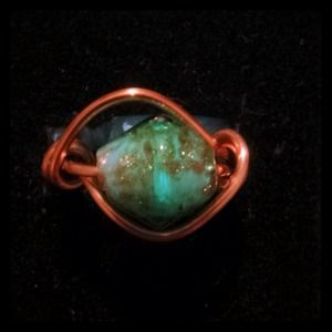 Wire wrapped ring with a specialized bead