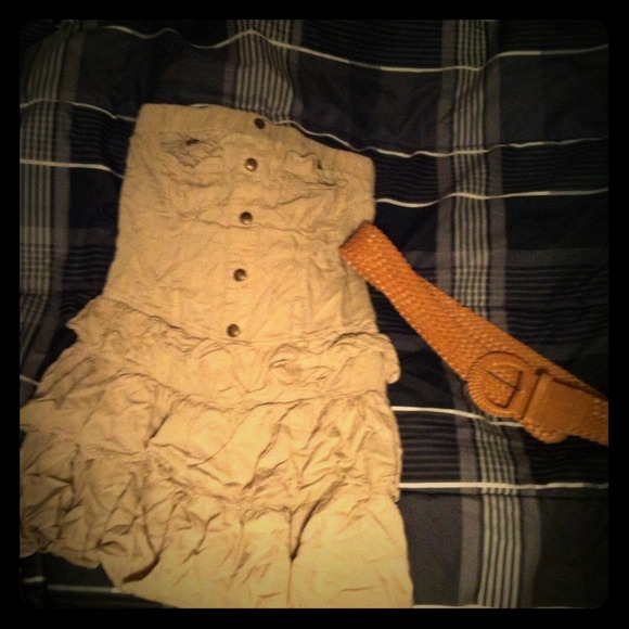 A khaki colored strapless dress plus belt