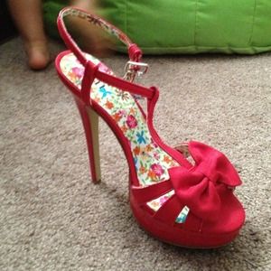 Red open strapy heels with an accent bow