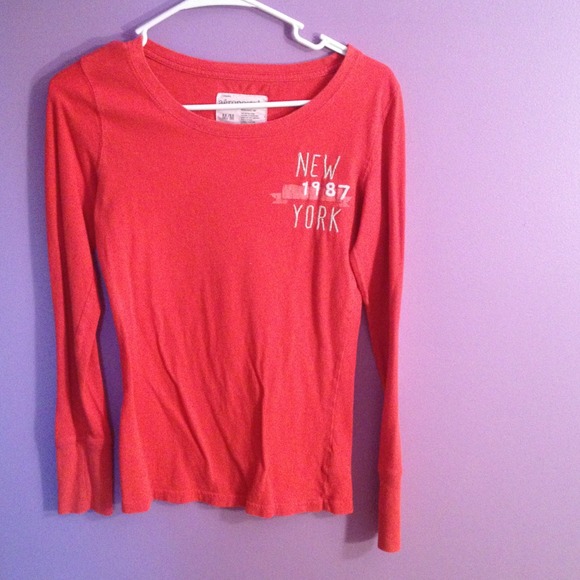 Orange long sleeved tee.