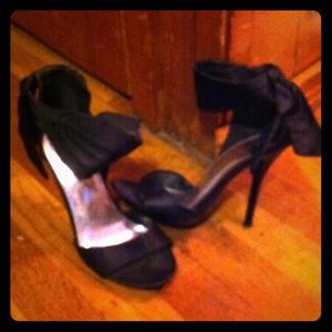 Black heel with black bow that wraps around ankle