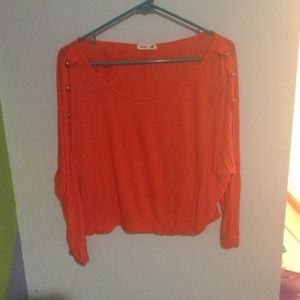 Orange cropped top; Gold accent buttons
