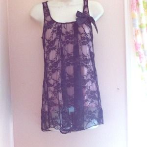 A pink top with lace coverage and a bow accent