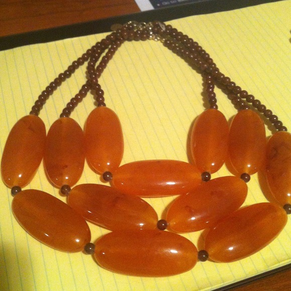 Necklace with three rows of beads/stones.