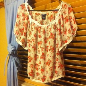 A see through shirt with pink and red flowers