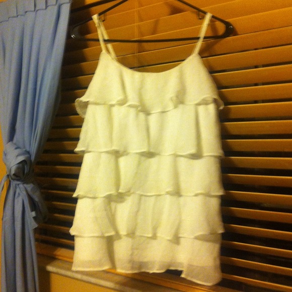 A Ruffled white and gold shirt