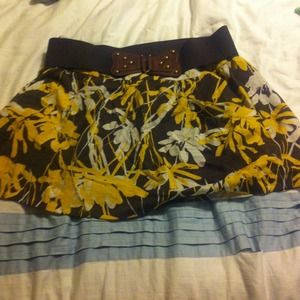 A brown,white and yellow skirt with a belt