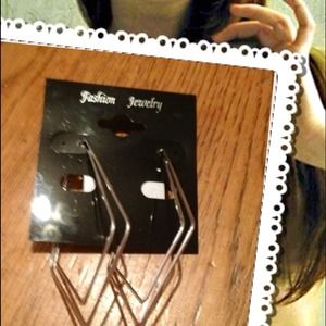 Silver tone triangle style earrings