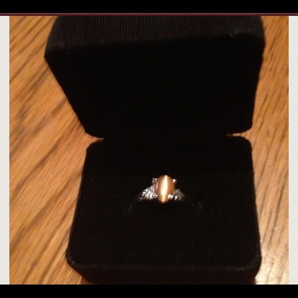 Silver ring with a smooth cut coral colored stone