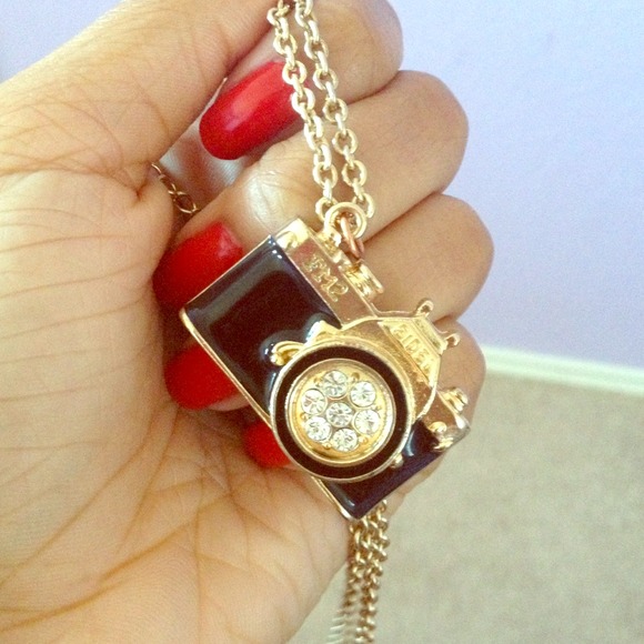 gold and black camera necklace