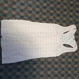 Flirty and fun racer back ruffle top!