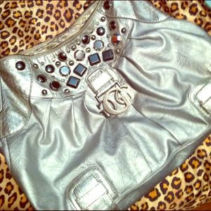 large, silver Guess handbag