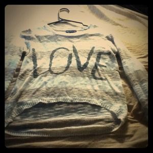 Brown and white stripped sweater that says love.