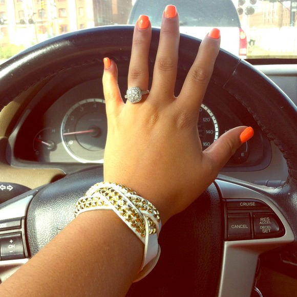 White bracelet cuff with gold accents.