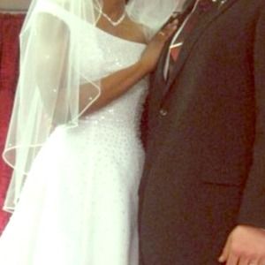 Pearl accented wedding gown with a mid size train.