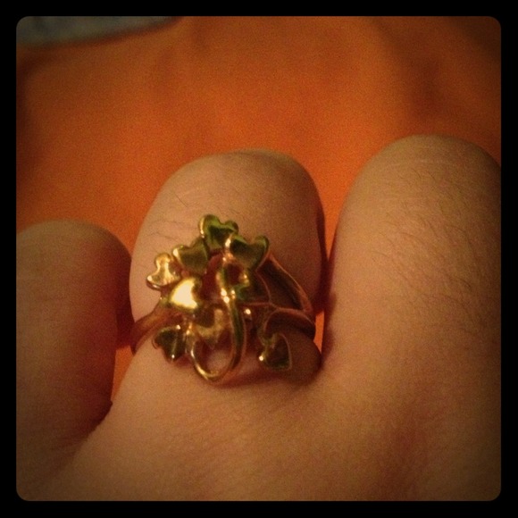 Gold ring and gold looped heart necklace charm.