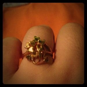 Gold ring and gold looped heart necklace charm.