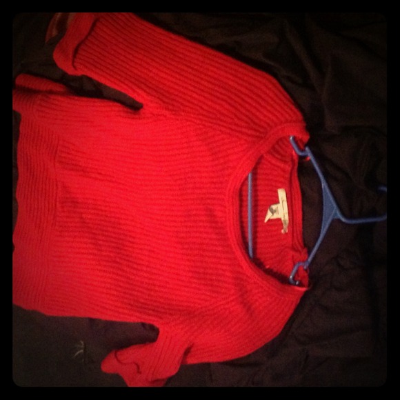 A red sweater, 55% cotton, 95% acrylic