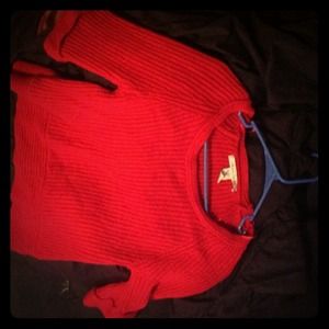A red sweater, 55% cotton, 95% acrylic