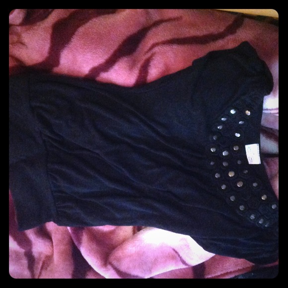 Black top with design around the neck.