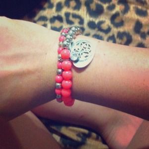 Neon orange/pink bracket with a heart