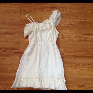 A white, lacey, one shoulder dress