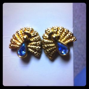 Golden peacock earrings with blue gem