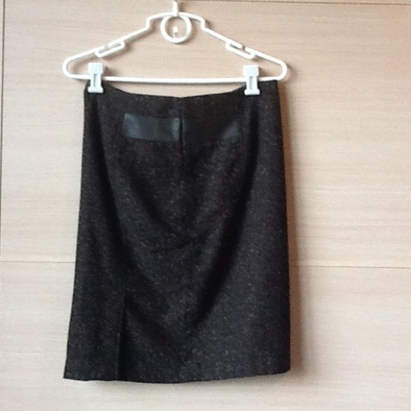 Wool skirt with soft foe leather accents.