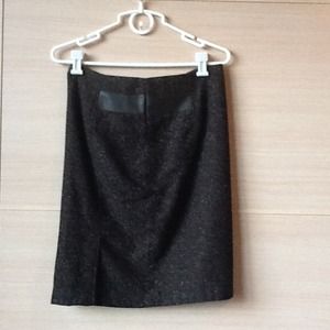 Wool skirt with soft foe leather accents.