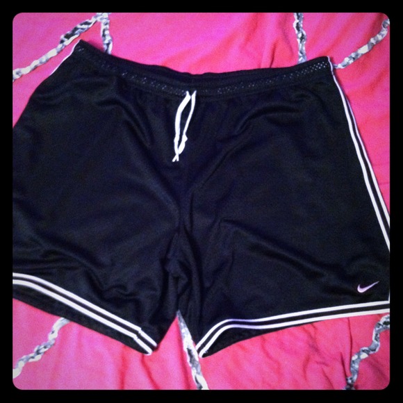 Black, white, and light pink pair of Nike shorts