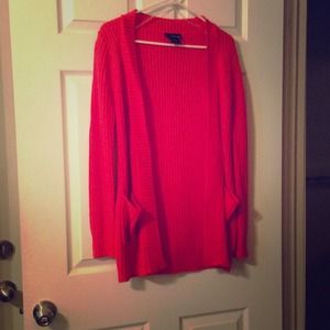 Orange sweater cardigan.