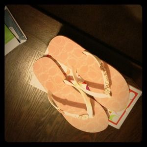 Pink coach flip flops.