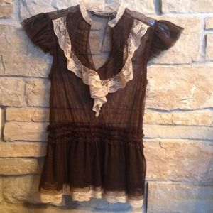 Sheer top with contrasting lace trim.