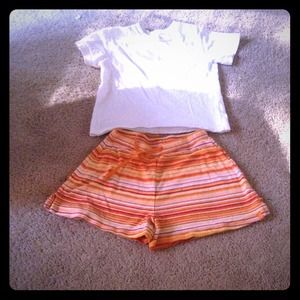 T-shirt, and orange shorts.