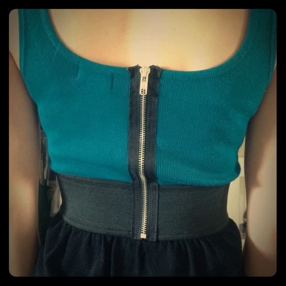Turquoise and black dress with exposed zipper.