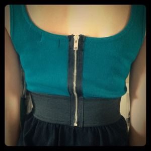 Turquoise and black dress with exposed zipper.