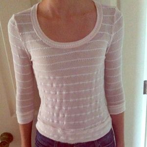 Cream colored knit top that's laced in the back.