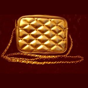 Gold purse with quilt stitching and gold studs