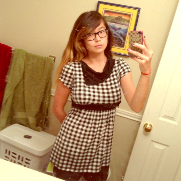 Black and white checkered shirt, button detail.