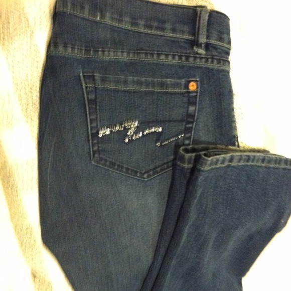 Rhinestone jeans worn with some stones missing
