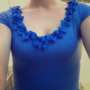A blue shirt with bows around the edges(: