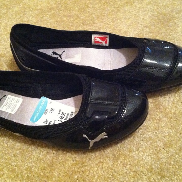 Black PUMA flats