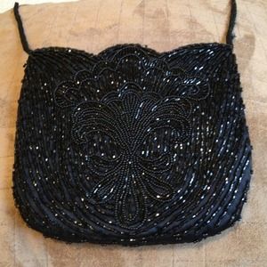 Black beaded evening bag with scalloped edges.